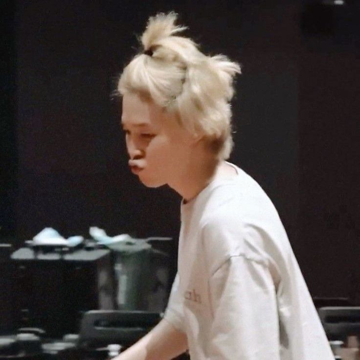 Jimin from Muse dance practice behind, he's in motion in the practice room, beakie is in full pushed out pout mode, his pretty blonde hair is in TWO ponytails this time, on of the top of his head and one further back