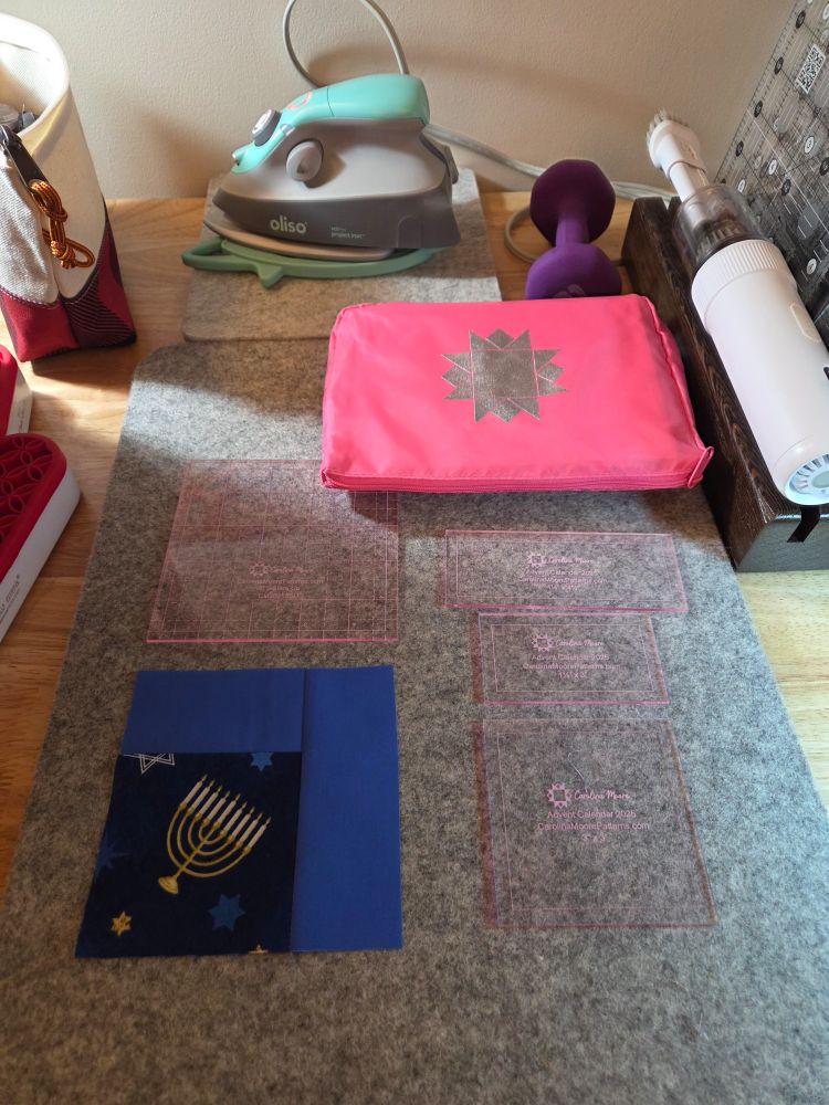 Simple log cabin in medium solid blue and dark blue with a Menorah.