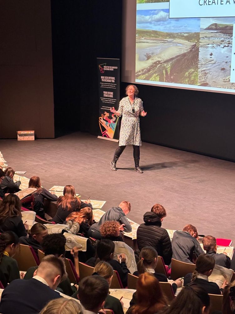 Me on a stage with lots of kids in the audience scribbling down their stories. 