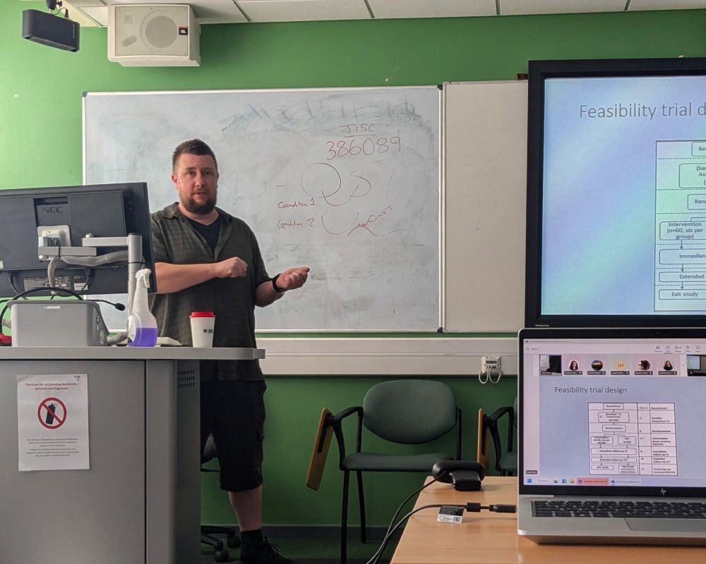 Image of Alan presenting one of the slides from the initial results of his research 