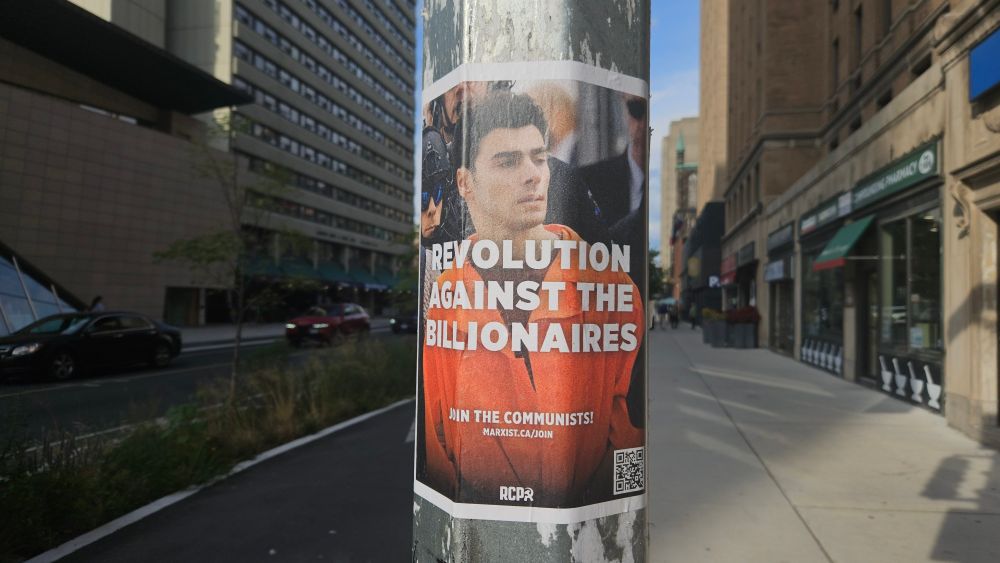 A poster of Luigi Mangione that reads, "Revolution against the billionaires."