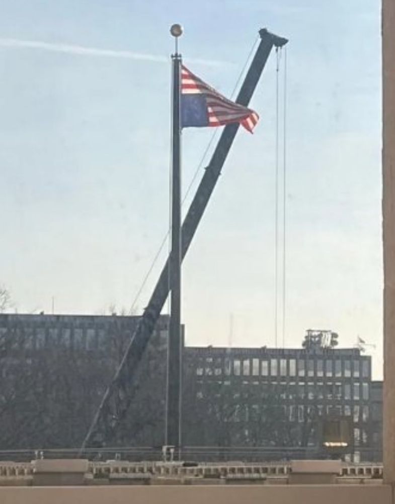 The flag pole at the state department with the American flag upside-down.