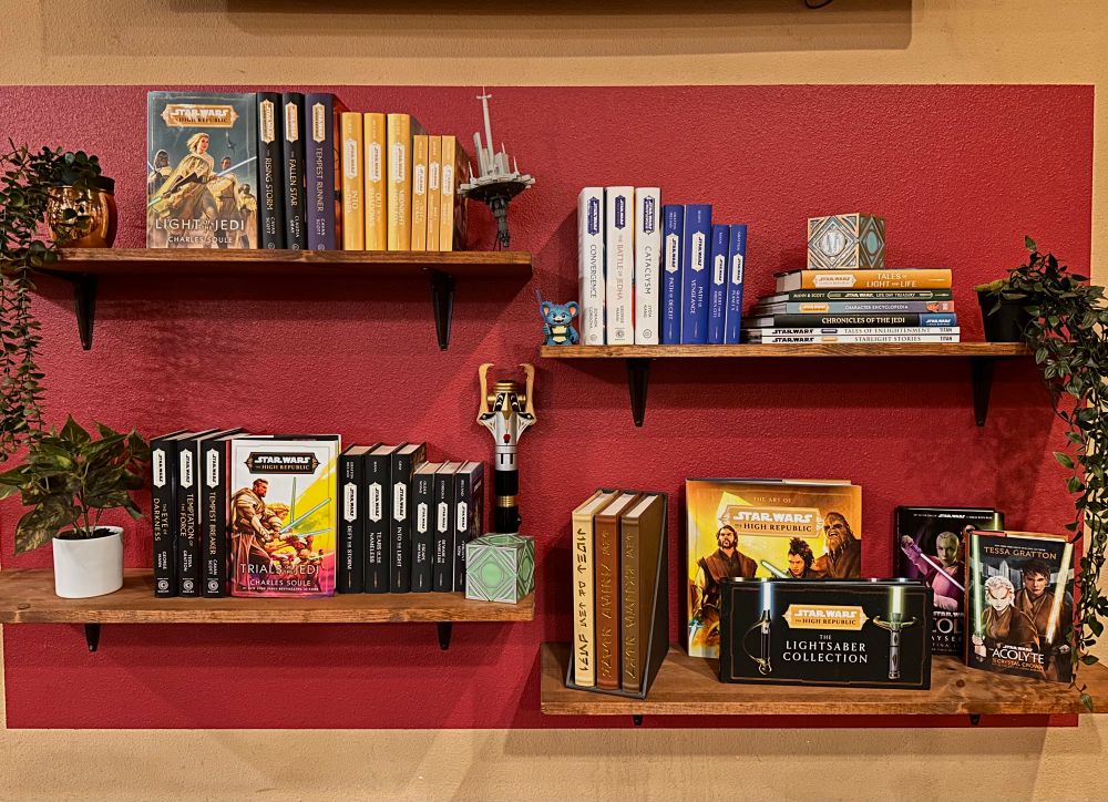Four small shelves with various High Republic books and trinkets. 
