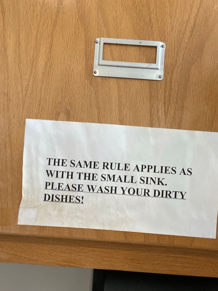 Paper sign (white with black text) reading:

THE SAME RULE APPLIES WITH THE SMALL SINK. PLEASE WASH YOUR DIRTY DISHES!