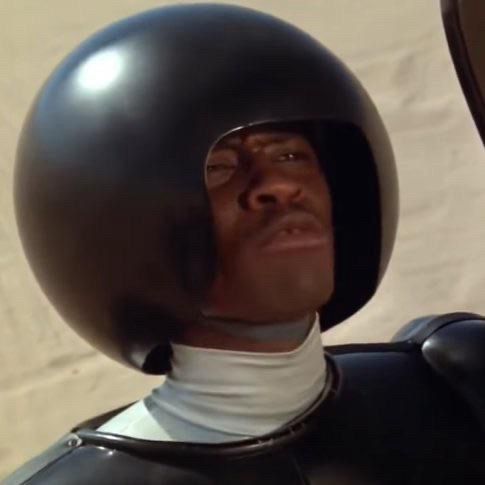 this is a photo of actor Tim Russ from his iconic scene in Spaceballs when he is combing the desert with a giant pick and says we ain’t found shit. 