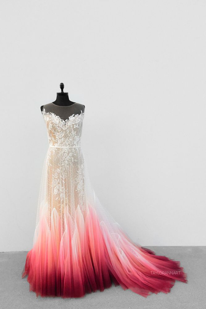 A wedding dress with an illusion neckline, floral applique, and soft a-line with a white to blood red ombre at the bottom that flares out.