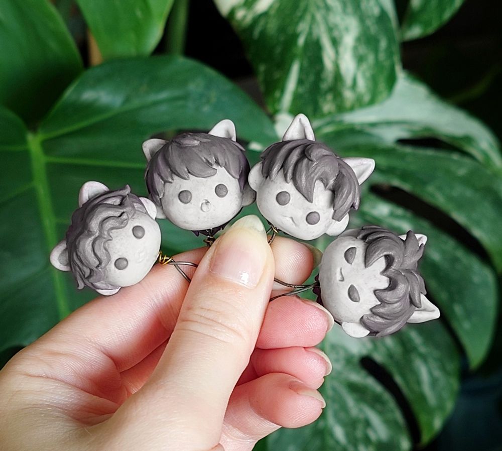 Chibi style heads made out of polymer clay, featuring Rafayel, Xavier, Zayne and Sylus as their catboy versions from the cat butler event