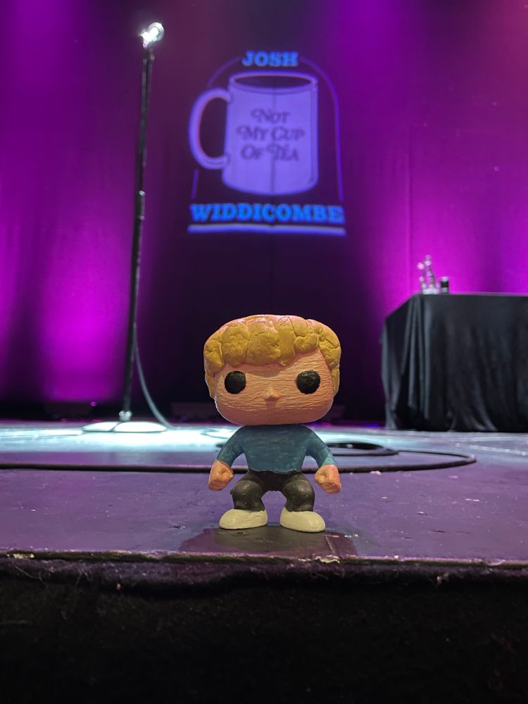 A photo of Mini Josh the mascot onstage with his namesake’s tour logo on the backdrop! He could’ve done the rest of the show and you wouldn’t have noticed the difference…