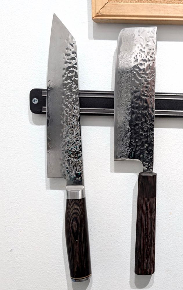 Two medium kitchen knives with folded carbon steel blade. One has a point and the other a blunt tip