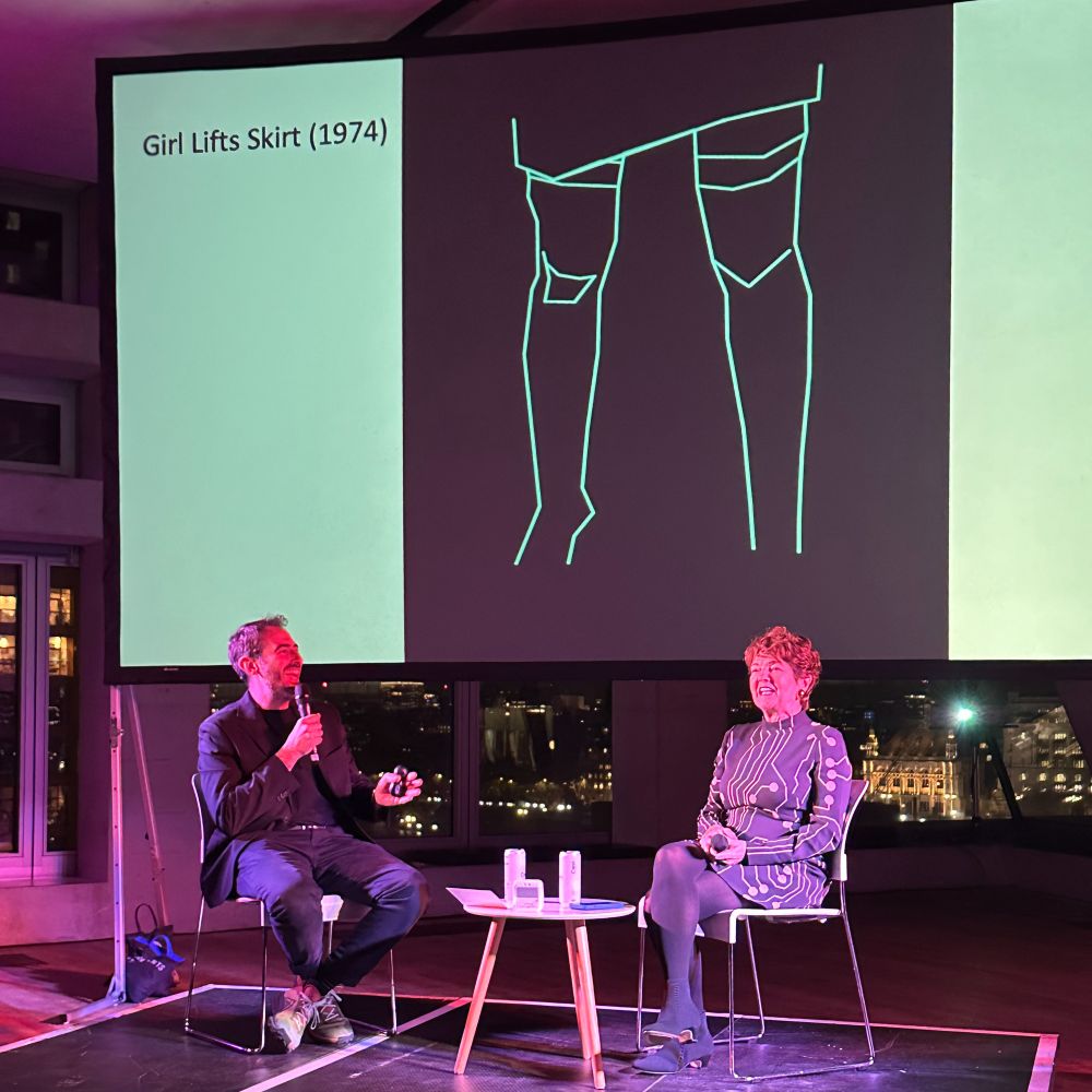 Rebecca Allen on stage, talking about Girl Lifts Skirt