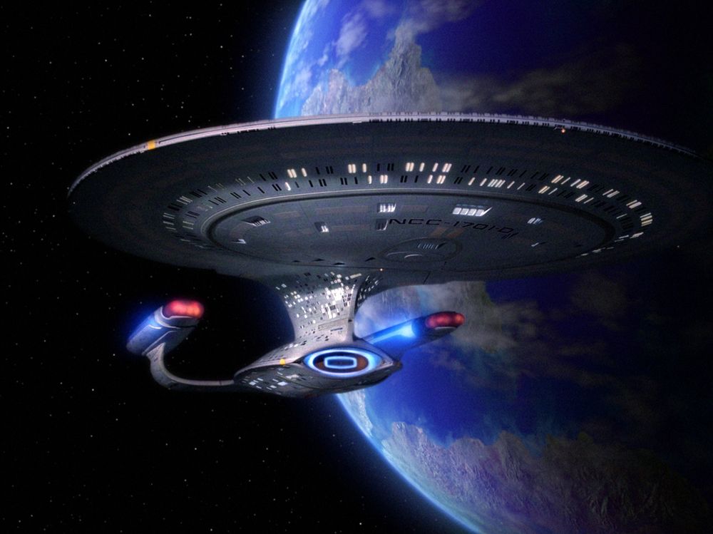 The Enterprise D in front of a blue-green planet, land and water. 