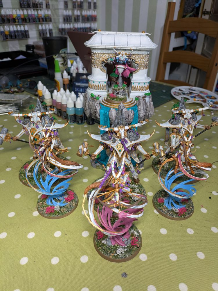 Lumineth army conditions of Spirits of the Wind and Mountain painted in a trans pride scheme