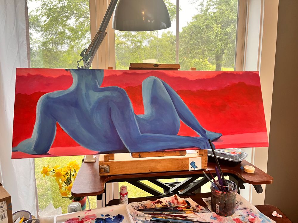 an acrylic painting of a blue nude figure reclining with a background of abstract pink and red