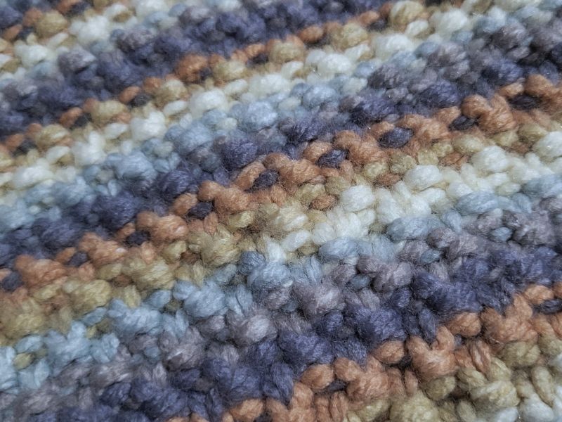 A closeup of the knitted Moss Stitch texture.
