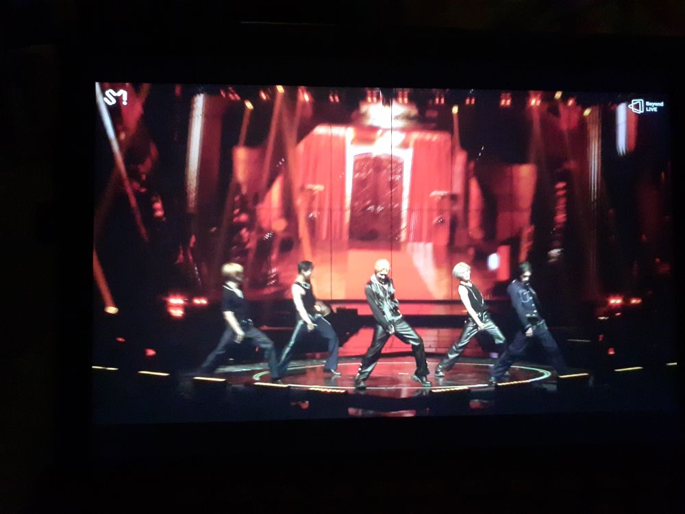 Blurred photo of my computer screen showing Wayv singing Nectar on stage at their No Way Out concert. All five members are lined up in a sexy pose