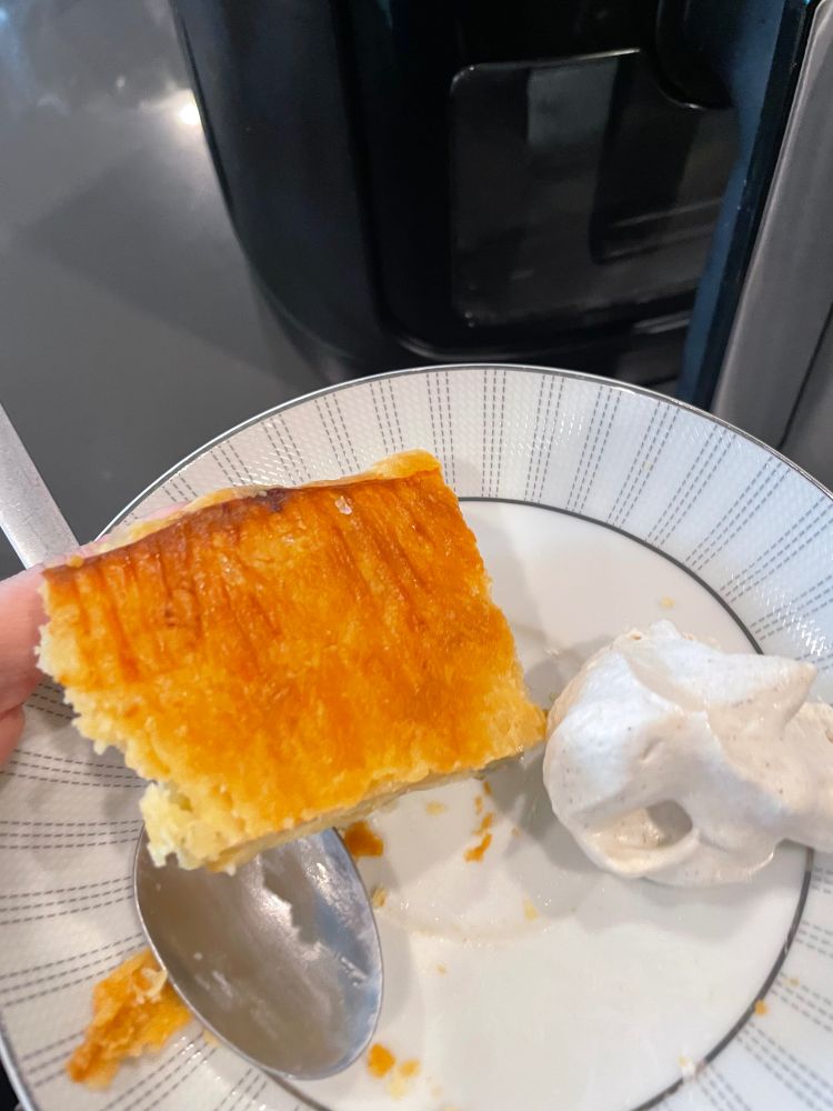 A slice of apple galette, turned upside down. The bottom crust is crispy and golden brown.