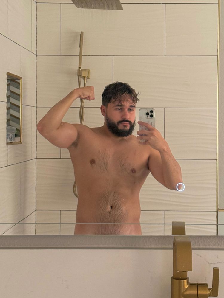 Mirror selfie while taking a shower. Flexing my right arm.