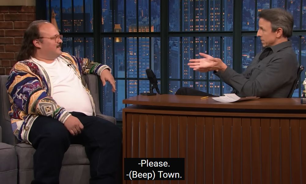 Stavros Halkias on Late Night with Seth Meyers the closed caption reads 
"-Please."
"-(Beep) Town."