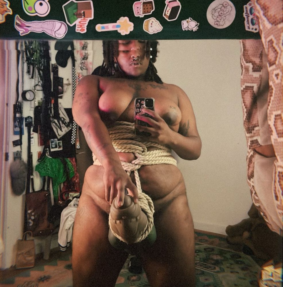 corso with a giant girthy alien cock tied up on him with thick jute rope. full length mirror picture and he is fully naked. 