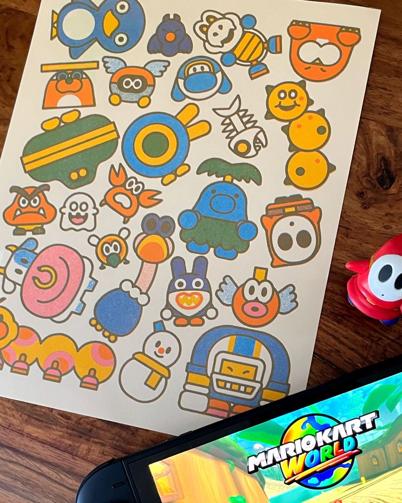 Photo of a risograph print of various characters from Mario Kart World, with a little Shy Guy figure and Switch 2 in the corner