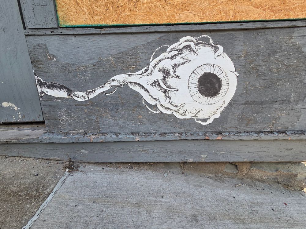 Graffiti of an eyeball on a building.