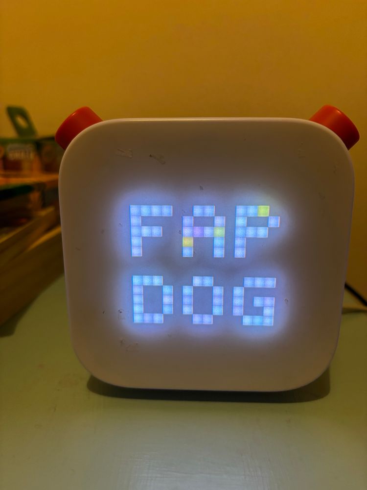 A photo of a Yoto player with six letters lit up on the display that say FAP DOG