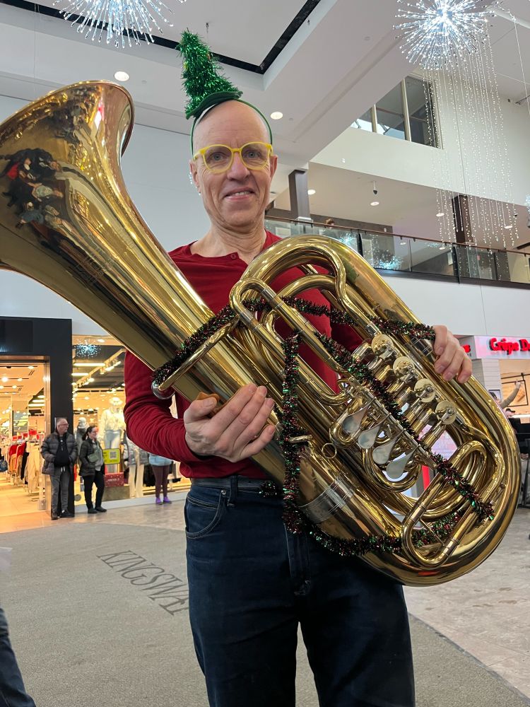 Scott standing with his tuba in Kingsway Mall