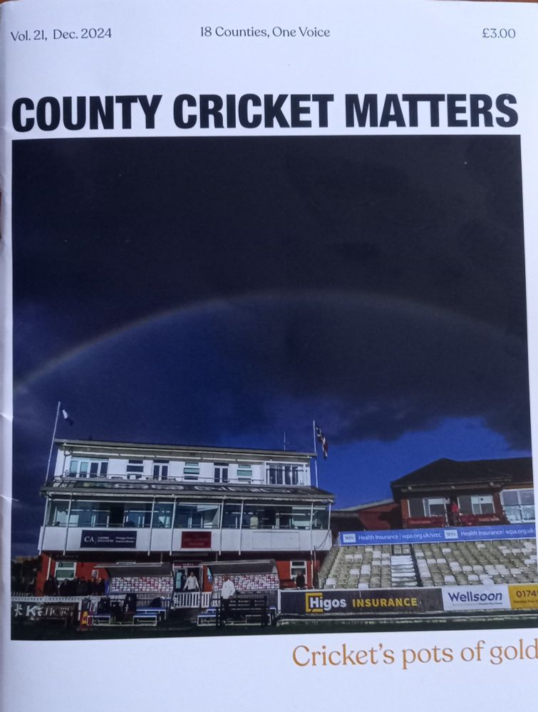 The cover of the Dec 2024 edition of County Cricket Matters - a dramatic picture of a double rainbow in a black sky above the cricket ground at Taunton, with the heading "Cricket's pots of gold".