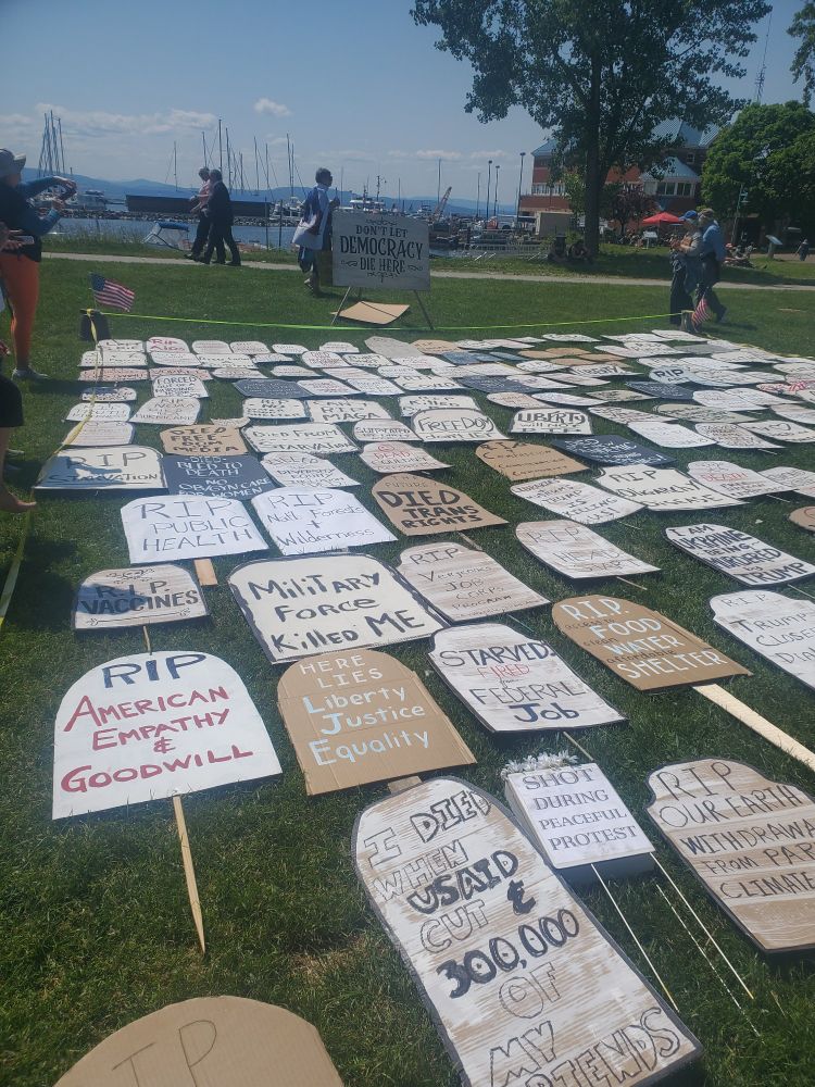 Tombstone signs protesting administrative cuts