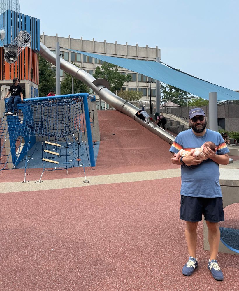Me standing in front of the cop slide, holding my daughter.