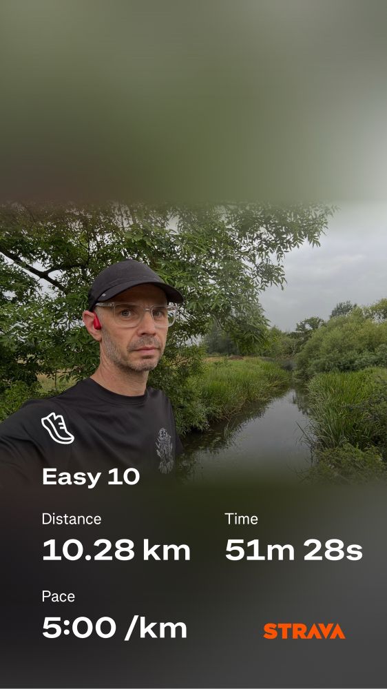 Stupid middle age baldy runner standing by a river. 