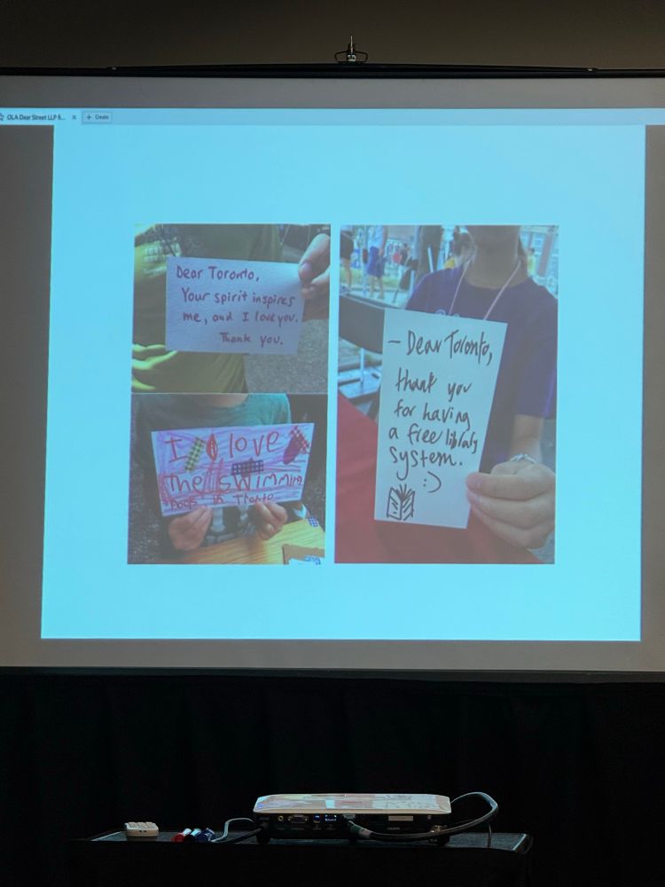 A slide of students holding up handwritten love letters to their city