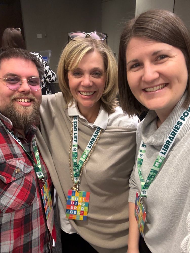 Joseph Jeffery from Prince George, Kelly Johnson from Richmond, and Shaunna MacDonald from Surrey. They are taking a selfie together with OLA Super Conference tags around their necks