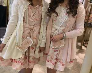 liz lisa x my melody 9th collaboration dresses worn by liz lisa workers, pink colorway on the left with a white cardigan, and white colorway on the right with a pink cardigan, both paired with the phonecase.