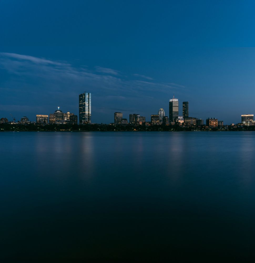 Boston skyline at dusk reflected in Charles River.