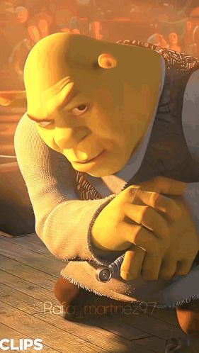 shrek from the movie shrek is kneeling down with his hands folded