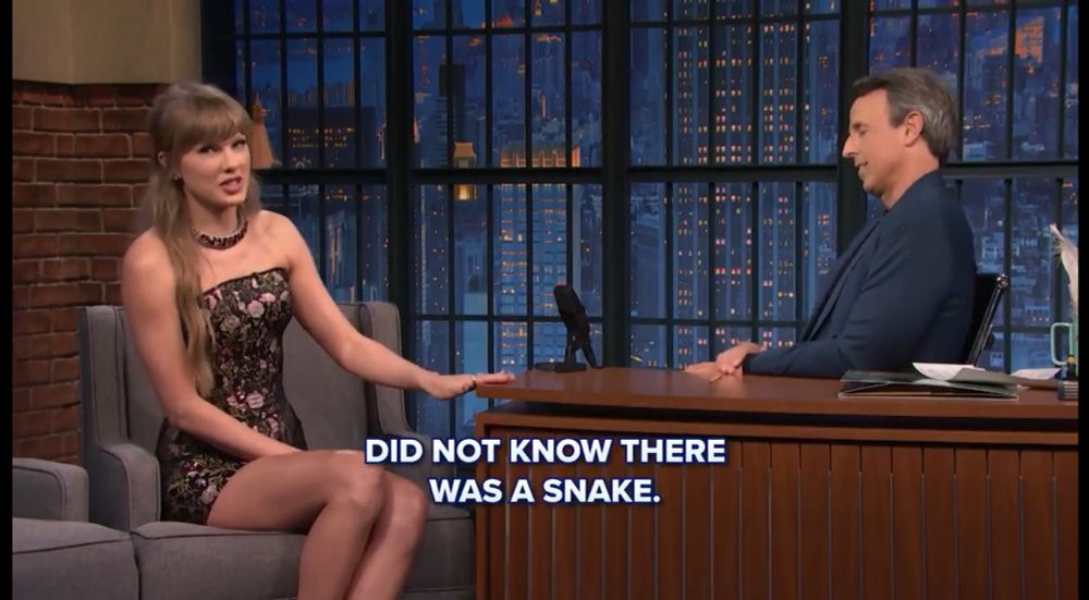 Taylor with Seth Meyers

Caption says “did not know there was a snake”