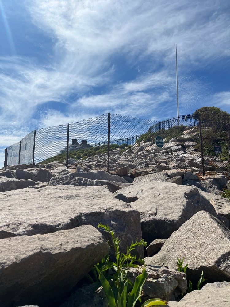 Huge rocks and two layer of fences separate the public beach from Holiday House