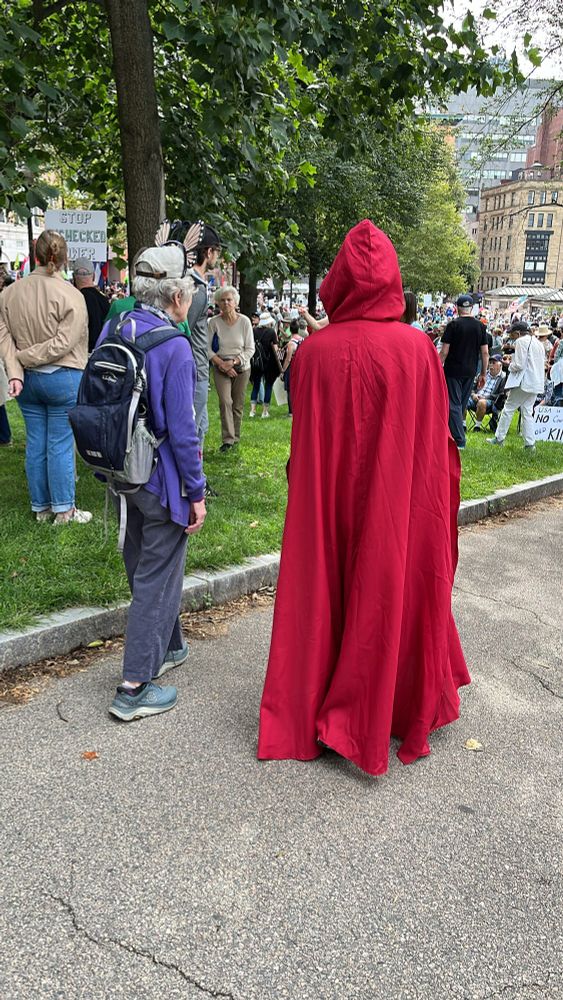 A woman dressed in a red cloak as a Handmaid 