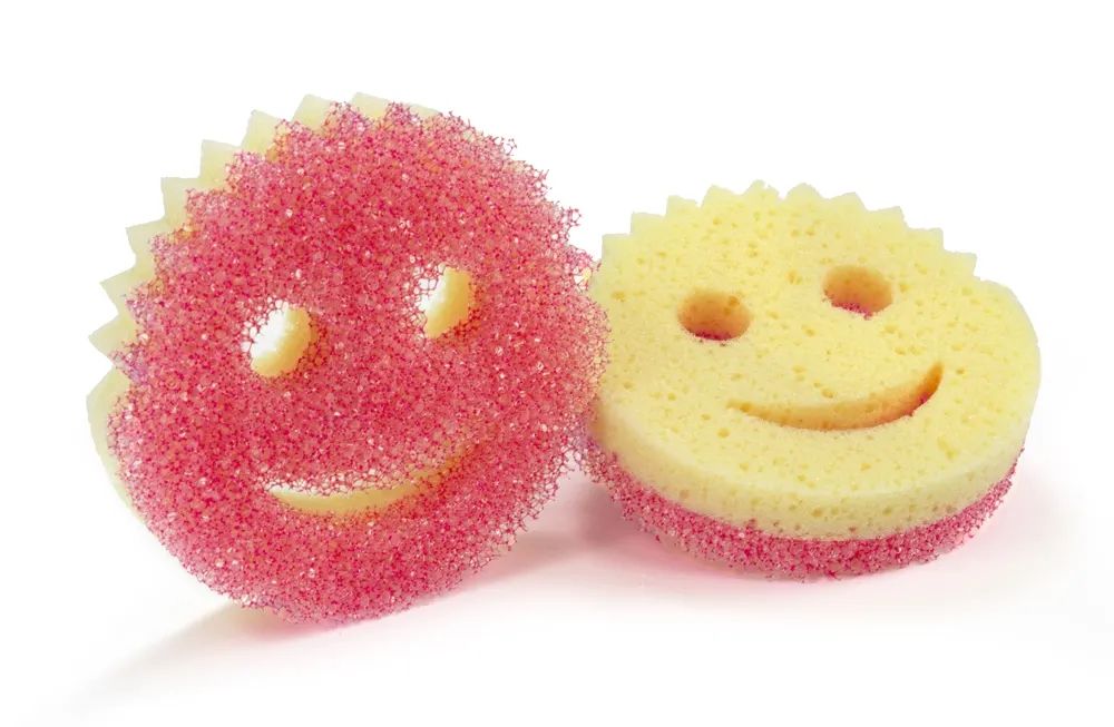 Picture of a scrub mommy which is a scrubber/sponge shaped like a smiley face. 