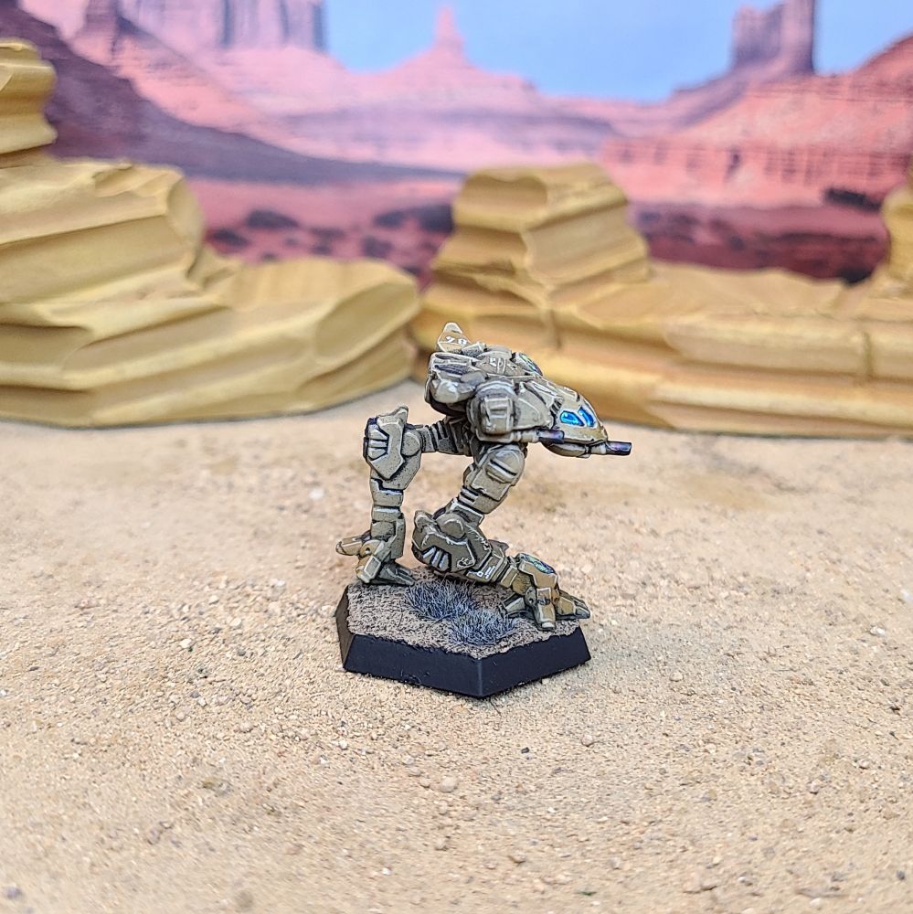 A Battletech Firefly miniature painted tan, green, brown, and blue. Right