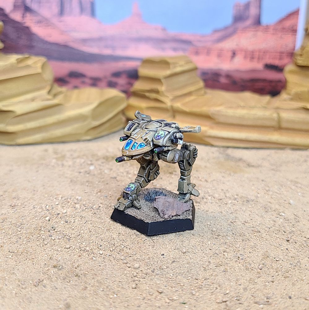 A Battletech Firefly miniature painted tan, green, brown, and blue. 3/4 left