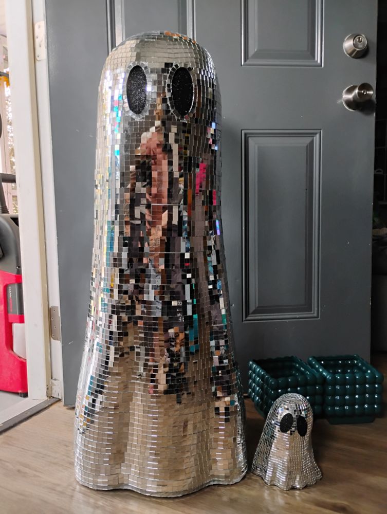 A photo of my large disco-ball ghost, next to my much much smaller disco-ball ghost.