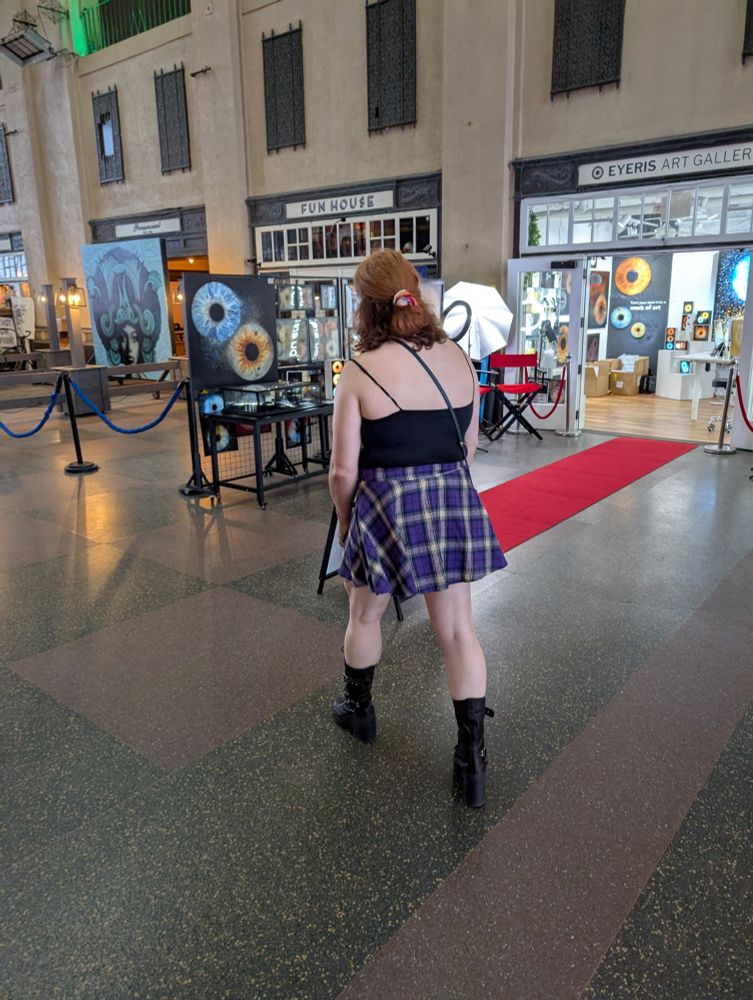 My girlfriend, Alannah, looking at photos of eyeballs in the Asbury Park shopping arcade 