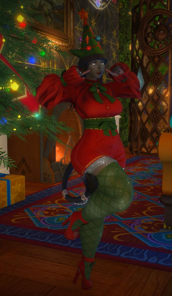 Lura smiling and pointing to her cheeks. She's dressed for Starlight in red and green and standing in front of their Starlight Sentinel.