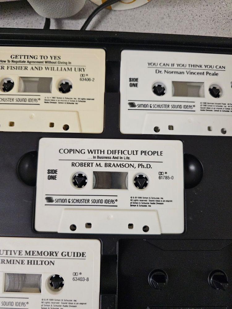 An image of cassette tapes. They are titled, "Getting to Yes", "You can if you think you can", "Coping with difficult people", and "Intuitive Memory Guide". 