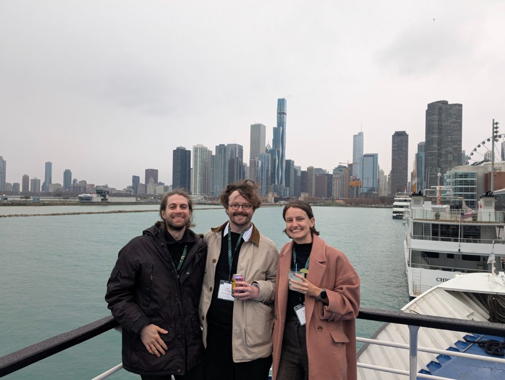 Picture of three scverse core members on the deck of a boat, with the Chicago skyline in the background.