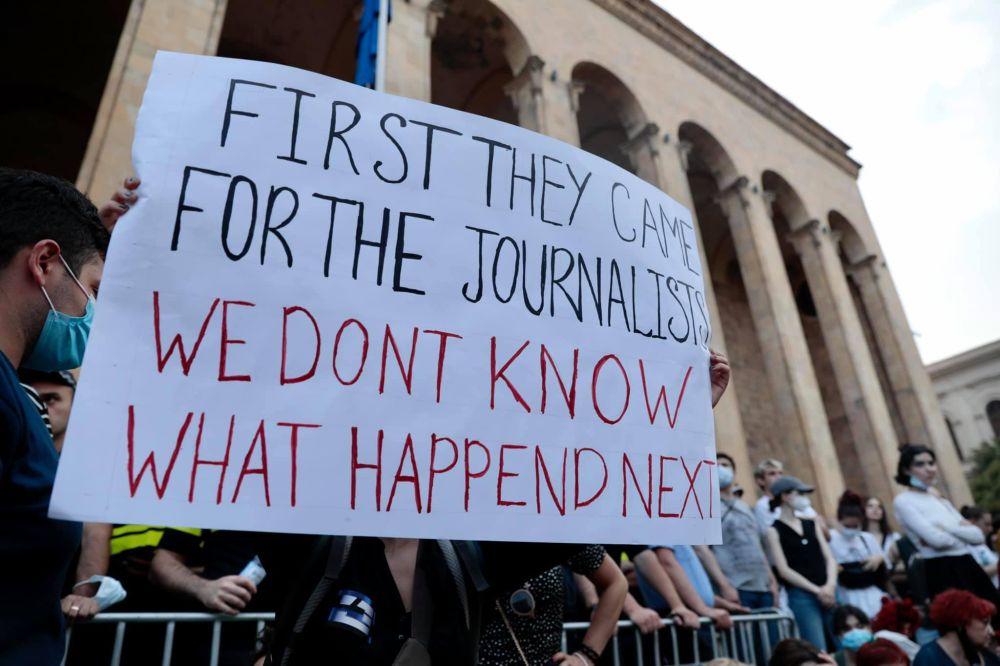 A banner that reads "First they came for the journalists. We don't know what happened next."