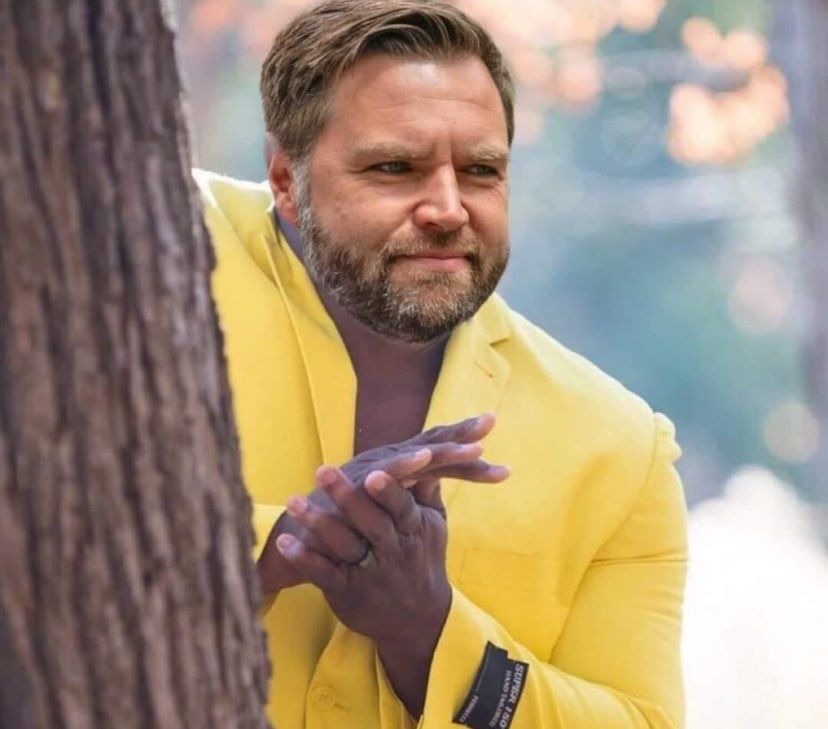 James Bowman (aka JD “Couch Fucker” Vance) wearing a yellow jacket and peeking from behind a tree. His face has been photoshopped onto a popular meme.