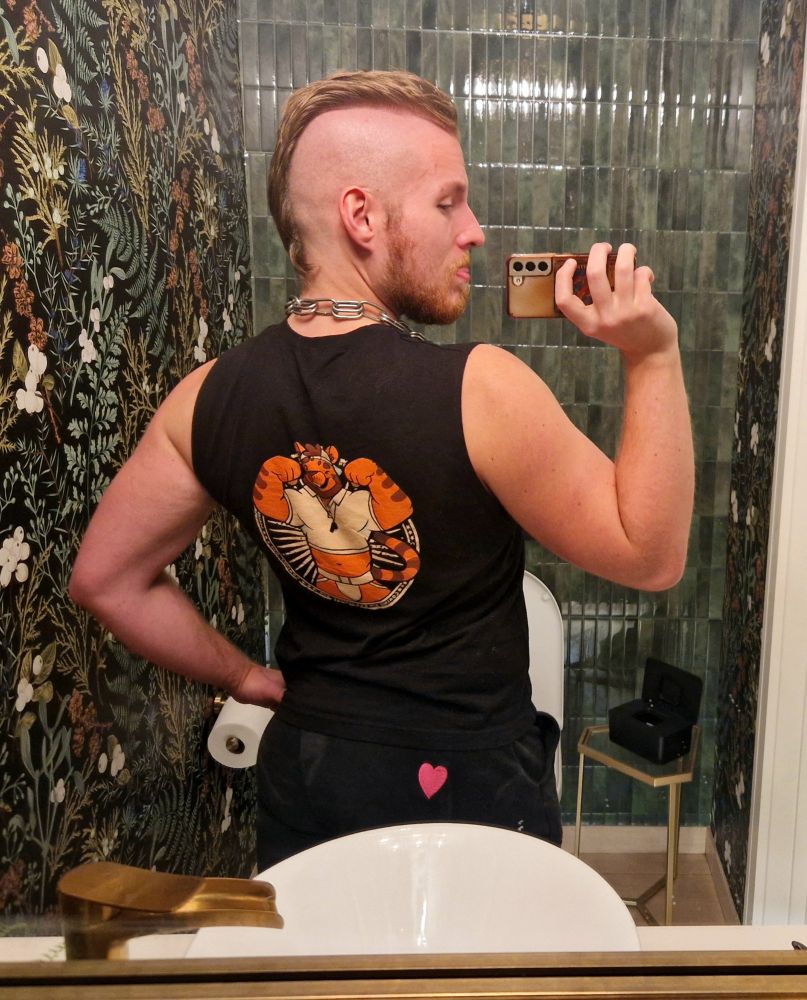 Me in same bathroom but from the backside, showing furry tiger jock drawing on the back of the tank